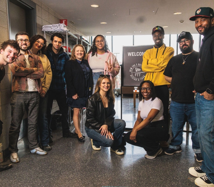 A group of students standing in front of a sign that reads Welcome to New Era Buffalo State Design a Thon