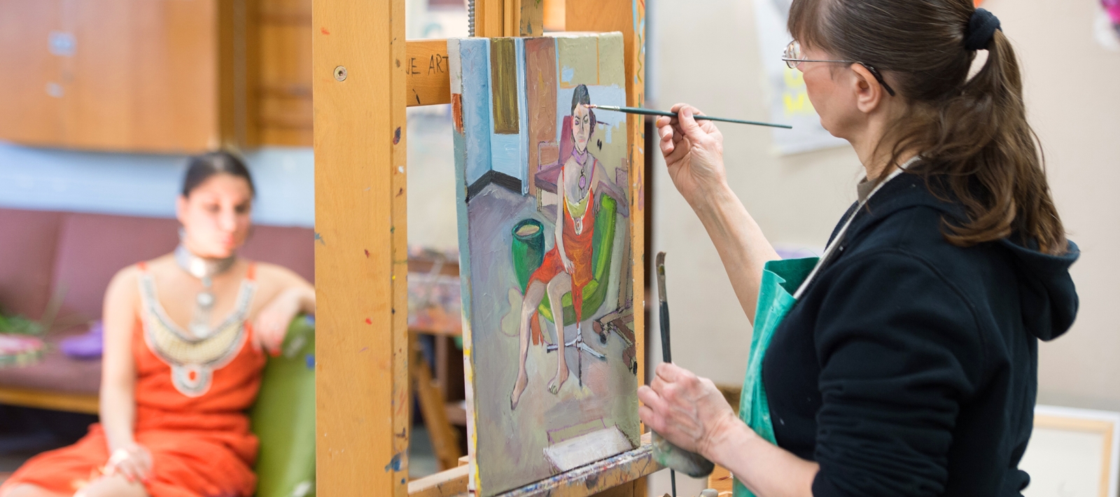 Student painting from a live model