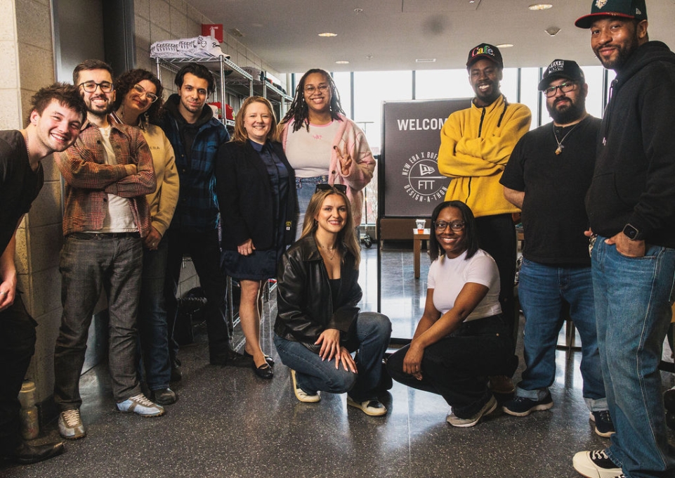 A group of students standing in front of a sign that reads Welcome to New Era Buffalo State Design a Thon